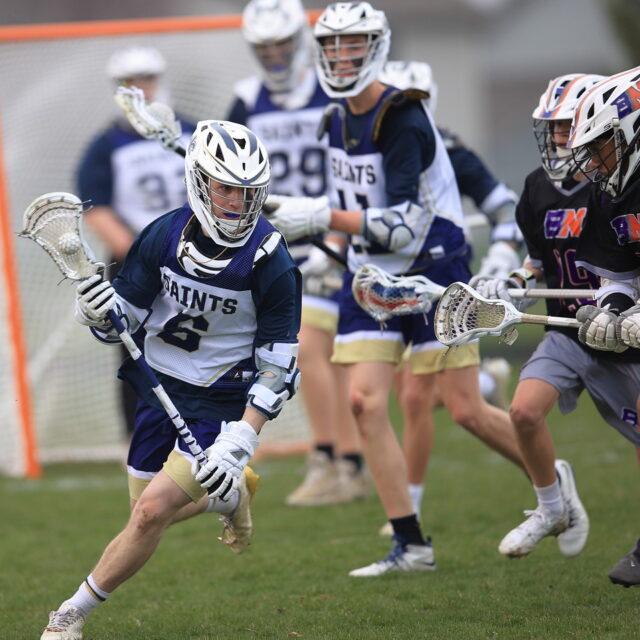 Lacrosse players in action during a competitive game.